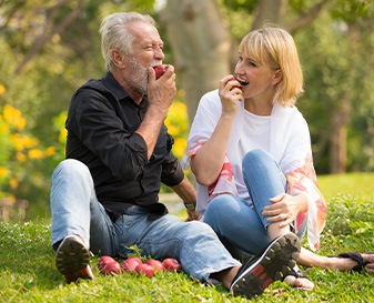 Two people eating apples
