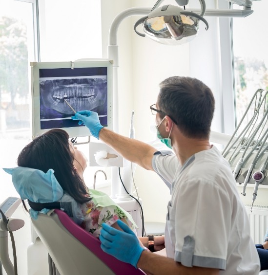 Dentist showing a patient x rays of their teeth