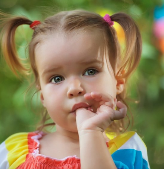 Toddler girl sucking her thumb