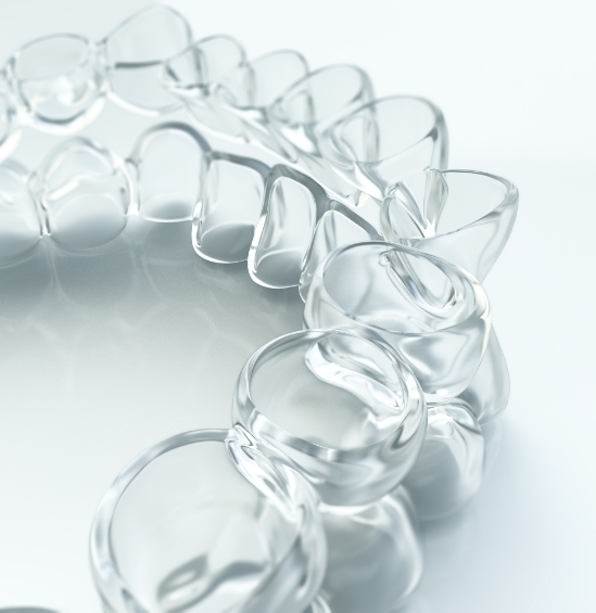 Close up of clear aligner on white surface