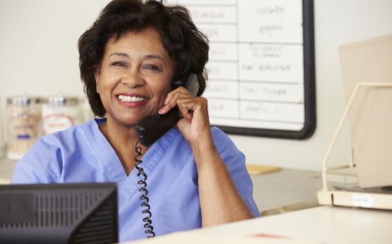 Smiling dental team member talking on phone