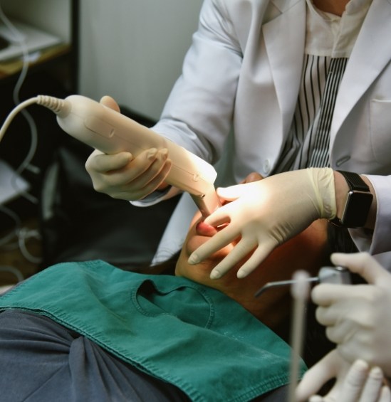 Dentist capturing digital dental impressions of a patient
