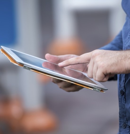 Person typing on tablet