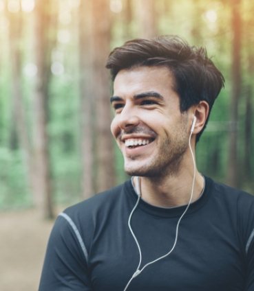 Smiling man wearing earbuds