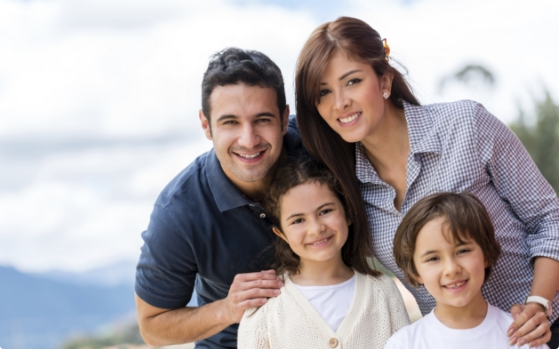 Family of four smiling outdoors