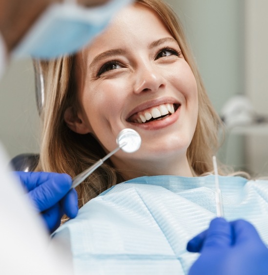 Woman smiling at her dentist during dental checkup