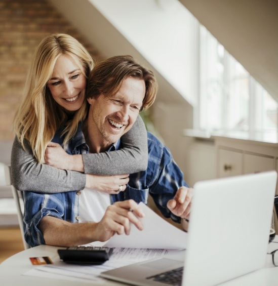 Man and woman looking at laptop together