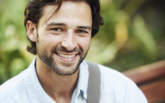 Man in white collared shirt smiling