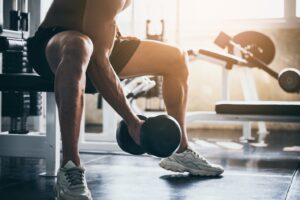 Man in gym lifting weights.